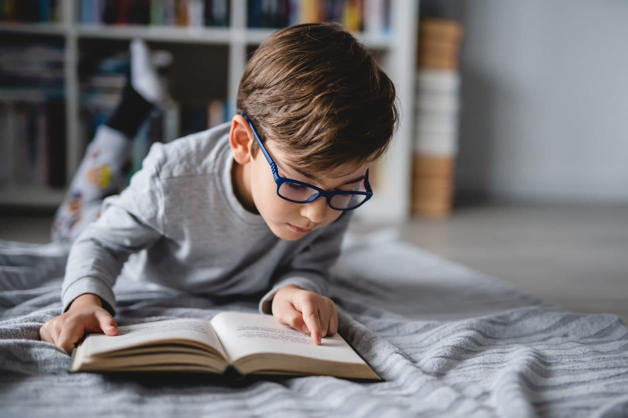Child reading a book during March Break
